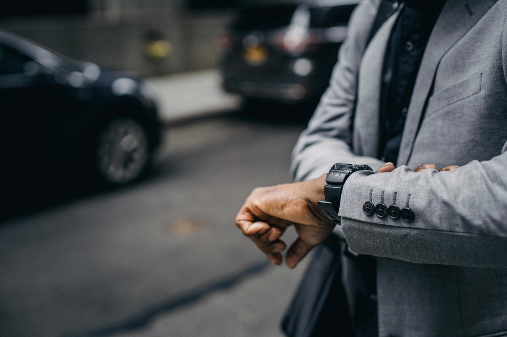 A man checking his watch, suggesting the importance of time management
